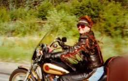 Cathy riding motorcycle near Silverton, CO.